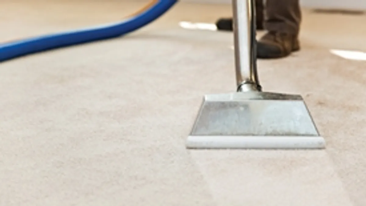 Carpet cleaning wand head gliding over a light carpet during hot-water extraction, Lincoln, NE.